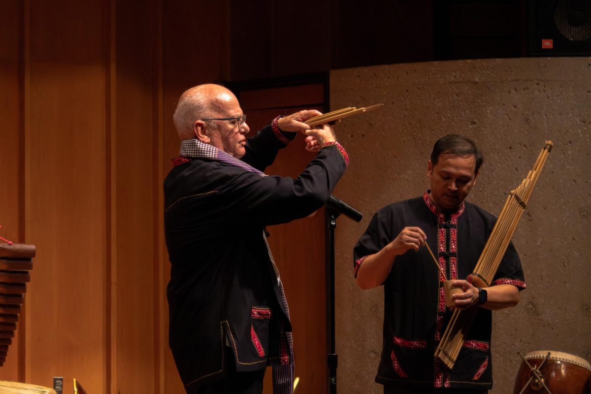 John Hartmann, former professor of Thai language and culture at NIU, introduces the instrument Wot and how it is constructed. Hartmann also mentioned the environment’s roles in crafting the instruments such as the species of bamboo used for the Khaen due to its long segments. (Totus Tuus Keely | Northern Star)