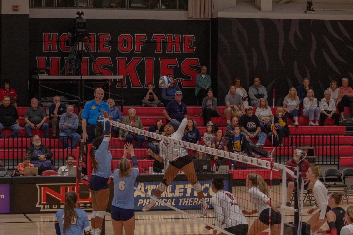 Junior right-side pin Alexa Hayes (12) spikes the ball for a kill on Oct. 10 at Victor E. Court. NIU volleyball lost to Western Michigan University on Tuesday as the Huskies were swept for the 11th time this season. (Northern Star File Photo)