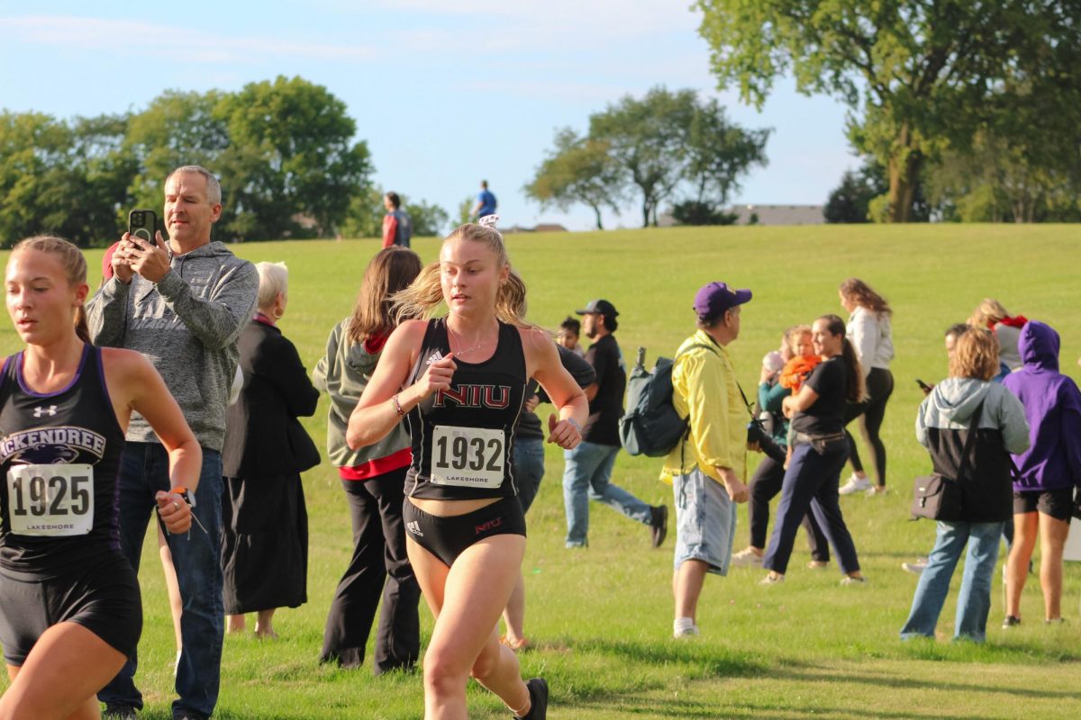 NIU cross country senior Olivia Southby runs right behind McKendree sophomore Lydia Trump. The Huskies finished in 12th place at the Mid-American Conference championship on Saturday. (Totus Tuus Keely | Northern Star)