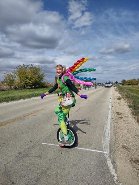 Gretchen Ivers, a second year master's student studying education for students with visual impairments and orientation and mobility, rides a unicycle at the Cortland Parade. Circus Club, now an approved club through SGA, meets from 8 p.m. to 9 p.m. Tuesdays in Gabel Hall 140.(Courtesy of Nam Pham)