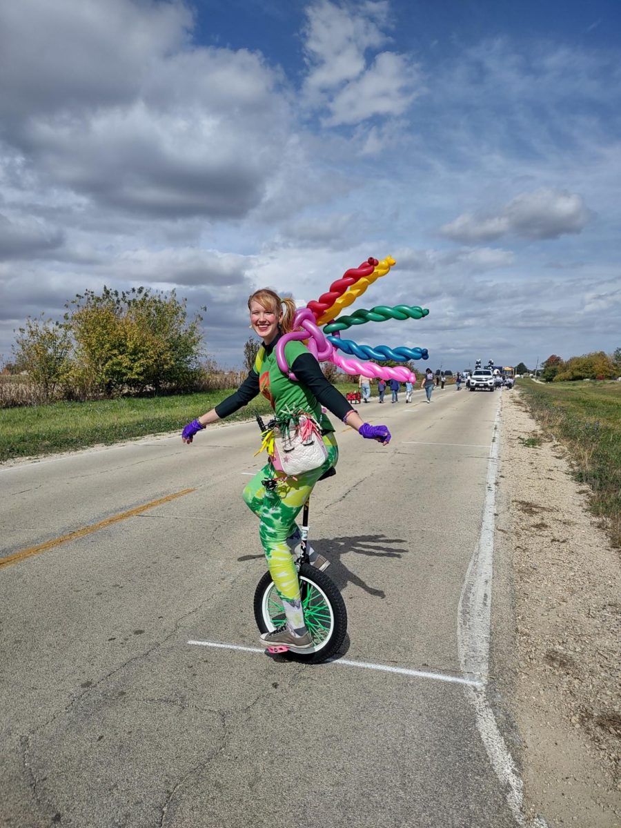 Gretchen Ivers, a second year master's student studying education for students with visual impairments and orientation and mobility, rides a unicycle at the Cortland Parade. Circus Club, now an approved club through SGA, meets from 8 p.m. to 9 p.m. Tuesdays in Gabel Hall 140.(Courtesy of Nam Pham)