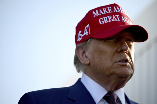 President-elect Donald Trump wears a Make America Great Again hat, which shadows his face. Opinion Columnist Santiago Montañez Bertoletti fears Trump’s proposed international policies will be dangerous for Europe and much of the rest of the world. (Brandon Bell/Pool via AP)