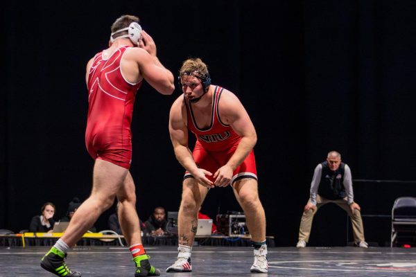 Redshirt junior Jacob Christensen stares down his Rider University opponent on Nov. 22 at the Convocation Center after his opponent broke free. Christensen competes as a heavyweight in the 285-pound weight class for NIU wrestling in 2024-25. (Totus Tuus Keely | Northern Star)