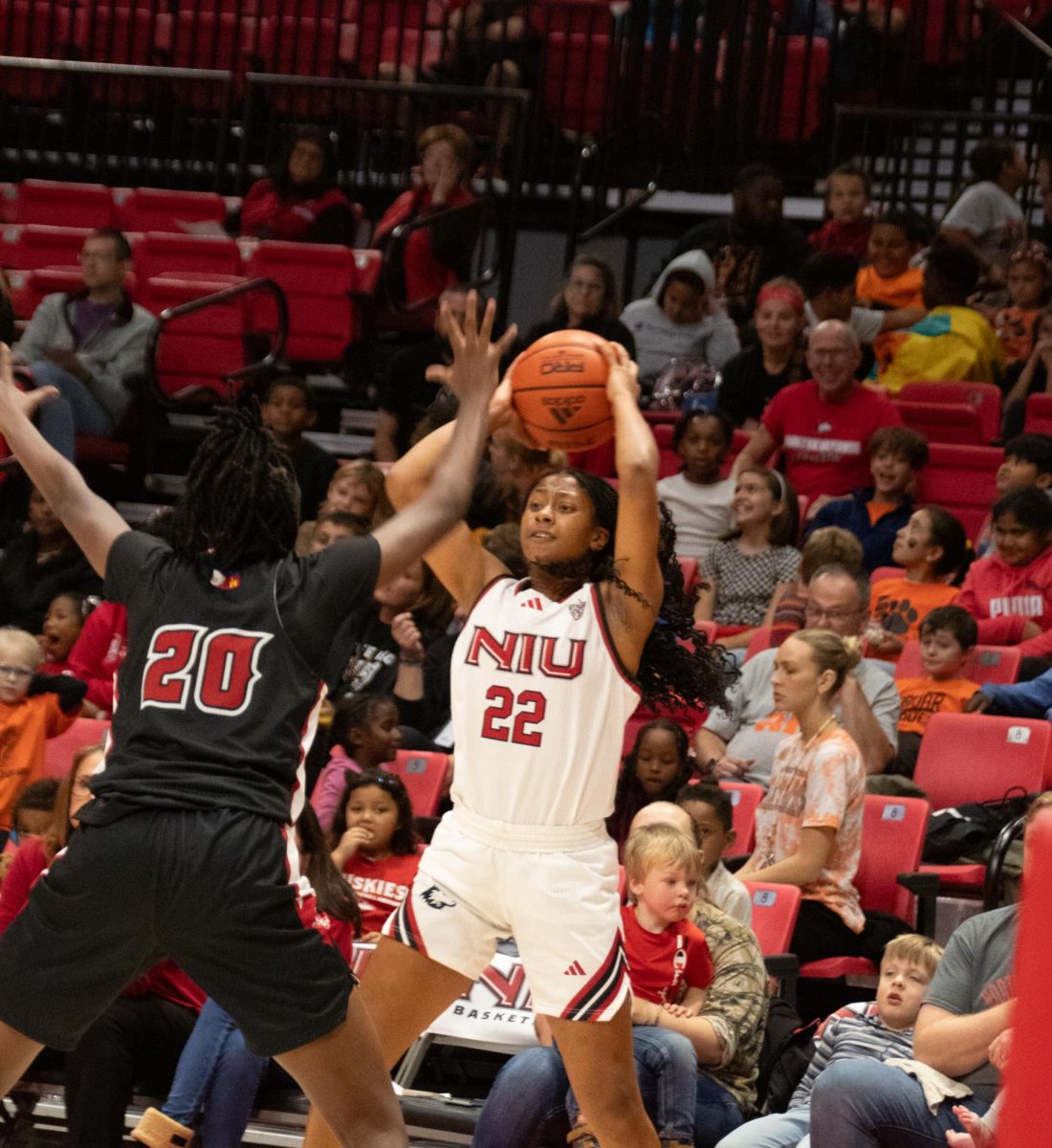 NIU women's basketball junior guard Alecia Doyle (22) looks for someone to pass to while University of Louisiana at Lafayette graduate guard Erica Lafayette (20) defends her. The Huskies' suffered their biggest loss of the season Saturday against the University of Missouri. (Katherine Follmer | Northern Star) 