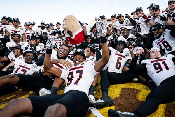 Members of the NIU football team celebrate, posing for a picture after defeating Fresno State University 28-20 on Monday in the Famous Idaho Potato Bowl at Albertsons Stadium in Boise, Idaho. The win improved NIU to a 2-1 bowl record under Hammock’s leadership. (Kenna Harbison | Boise State University Athletics)