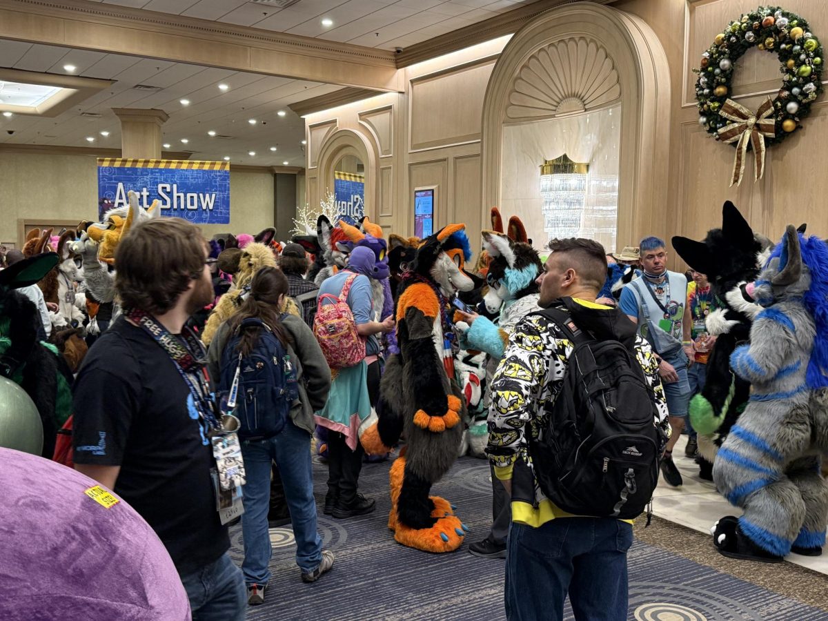 A group of fursuiters at Midwest FurFest wait outside an area that is labelled by a hanging sign that says “Art Show”. NIU’s furry club is focused on the furry subculture which, at its core, is an art-centric community. (Ryan Day | Northern Star)