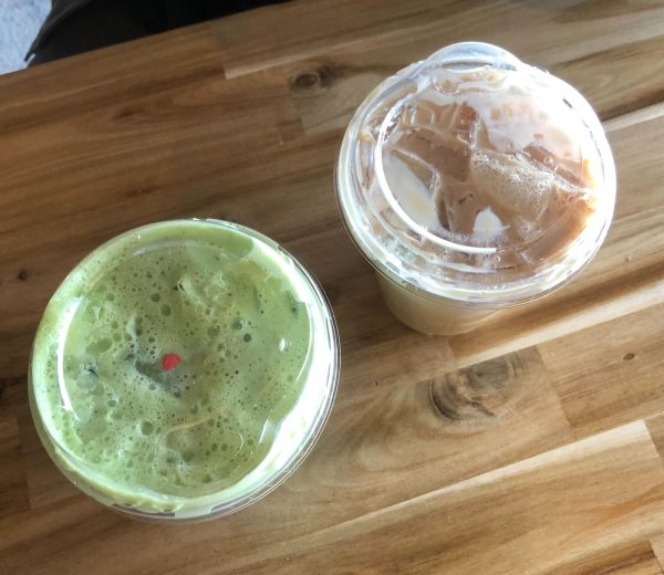 Two drinks from Cast Iron Coffee, located at 901 Lucinda Ave. Suite D, sit ready to be enjoyed. One of Cast Iron’s many holiday drinks, the Grinch matcha, includes a single Grinch heart sprinkle. (Jenny Javkhlantugs | Northern Star)