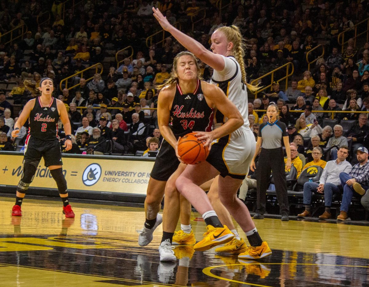 NIU women's basketball graduate student Brooke Stonebraker drives toward the hoop, making contact with a University of Iowa defender in NIU's 91-73 loss against Iowa on Nov. 6. This season, the Huskies currently sit at a record of 3-3. (Joseph Segreti | Northern Star)