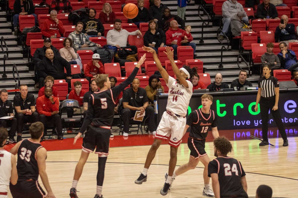 Senior guard James Dent Jr. (14) shoots a fade-away jumper against Benedictine University on Tuesday at the Convocation Center. Dent is averaging 13.6 points per game as NIU men's basketball stands at 3-6 on the season. (Tim Dodge | Northern Star)