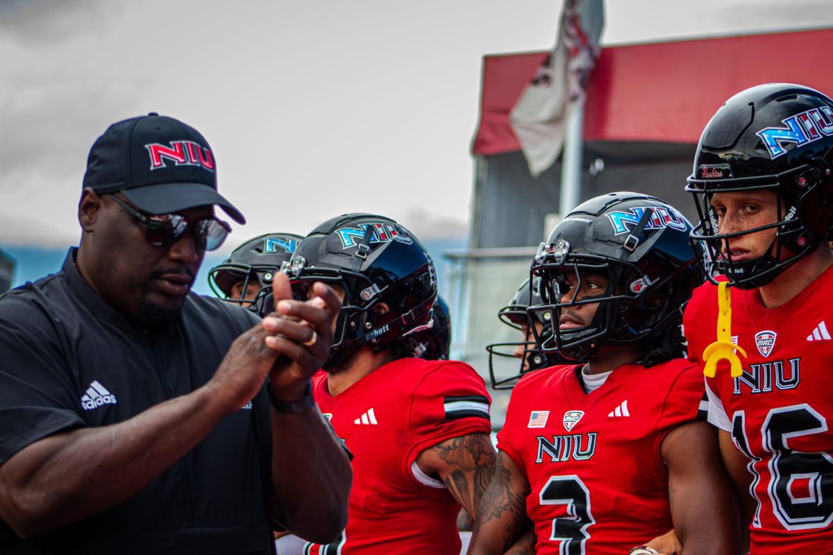 NIU football head coach Thomas Hammock (left) hypes up his players before they run onto the field for a game against the University at Buffalo on Sept. 21 at Huskie Stadium in DeKalb. Hammock added 19 freshmen and two transfers to NIU’s 2025 signing class on the first day of the NCAA’s early signing period Wednesday. (Totus Tuus Keely | Northern Star)