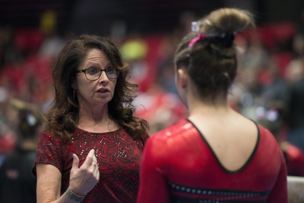 NIU gymnastics interim head coach Dawnita Teague speaks with an NIU gymnast at the Convocation Center. Teague has coached at NIU since 2007 and now fills the empty position left by Sam Morreale's retirement on Sept. 26. (Courtesy of NIU Athletics)