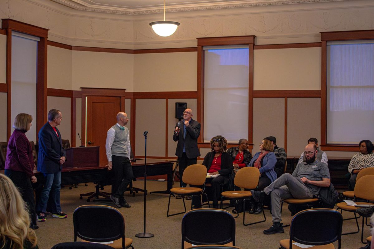 William Martin, assistant professor of biology, asks a question to John Acardo, senior associate vice president and chief human resources officer, Laurie Elish-Piper, executive vice president and provost, and George Middlemist, chief financial officer, during the University Council’s meeting Wednesday. Acardo, Middlemist and Elish-Piper gave a joint presentation about NIU's deficit and mitigation strategies to members of University Council. (Totus Tuus Keely | Northern Star)