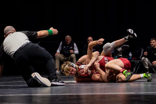 Redshirt sophomore Jacob Brya wraps around Rider University graduate student McKenzie Bell from behind on Nov. 22 at the Convocation Center. Brya took third place in the 141 lbs. division at the Cougar Clash on Saturday as NIU wrestling took fifth place out of eight teams. (Northern Star File Photo)