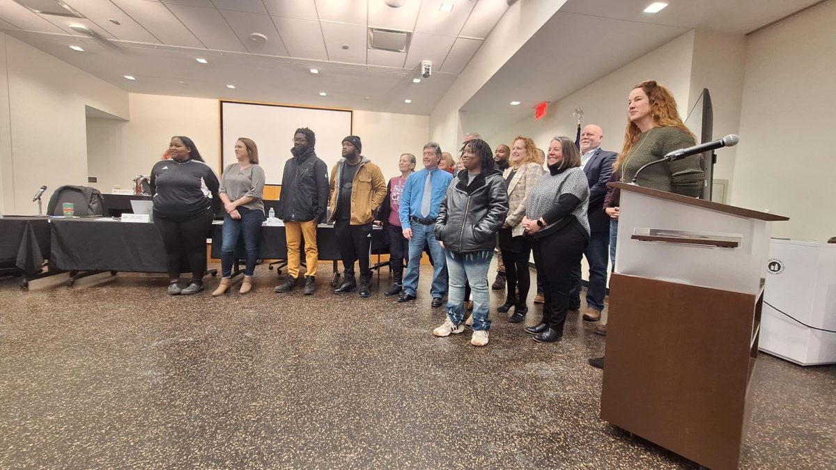 The DeKalb city council takes a photo at its Jan. 13 meeting with residents of buildings affected in the Dec. 22 Hillcrest apartment fire and community members who were involved in the aid process. (Joseph Ndu | Northern Star)