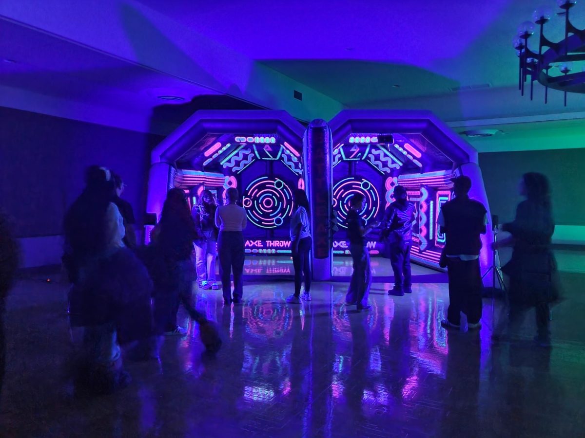 Visitors line up to hurl axes at the targets. The Campus Activity Board held their "Glow at Holmes" event which featured several glow-in-the-dark activities. (Jonathan Shelby | Northern Star)