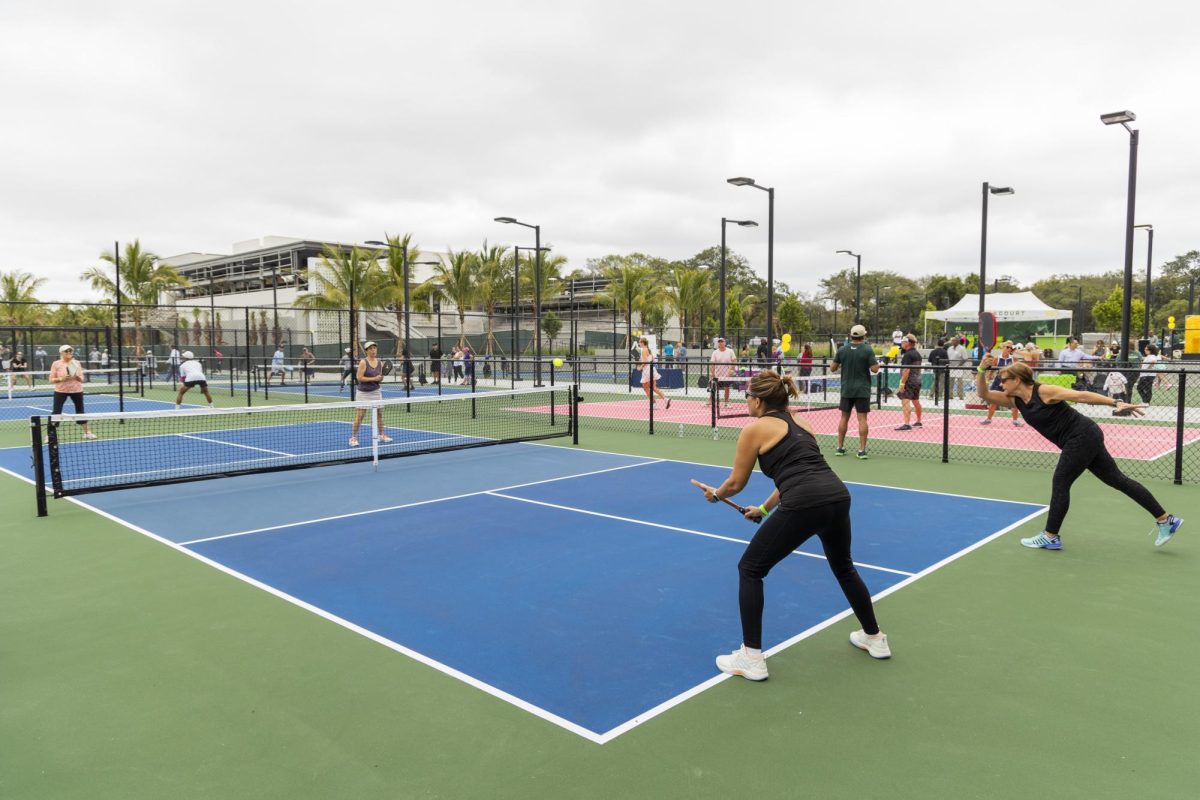 A group of adults play pickleball during the "In the Kitchen" community event which took place Tuesday. Opinion Columnist Ethan Ernst believes more emphasis should be placed on people living a healthy lifestyle in order to avoid contracting conditions such as cancer or heart disease versus treating these conditions once they occur. (Jesus Aranguren | AP Photo)