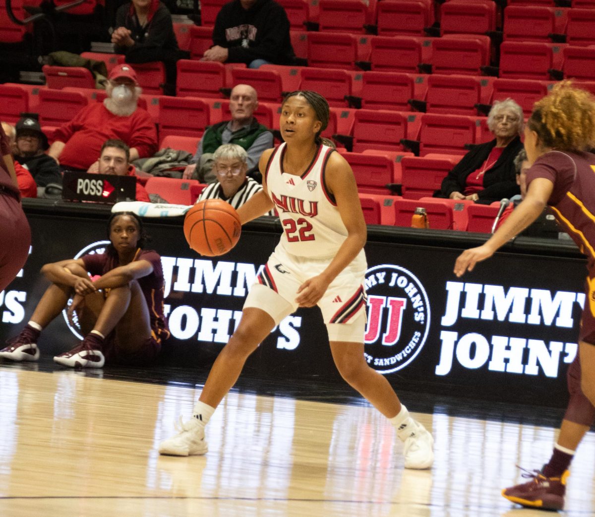 NIU women's basketball junior guard Alecia Doyle (22) looks for a teammate to pass to Wednesday against the Central Michigan University Chippewas at the Convocation Center. The Huskies fended off the Chippewas' late-game rally, defeating Central Michigan by a score of 80-75. (Katherine Follmer | Northern Star)