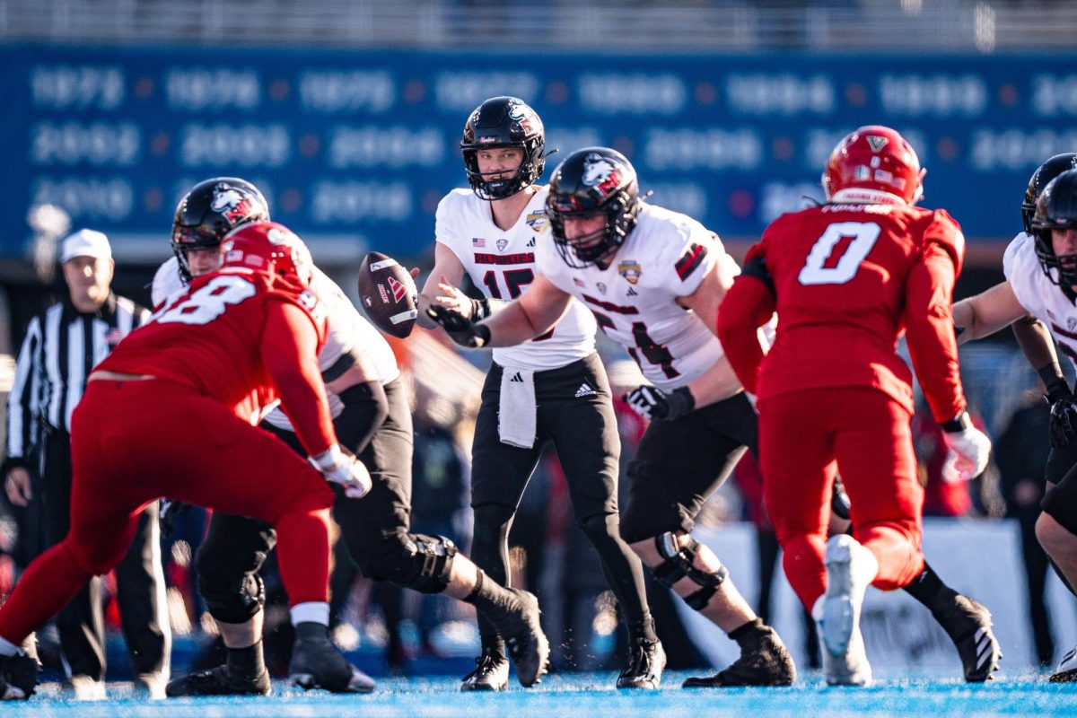 NIU redshirt freshman quarterback Josh Holst (15) takes a snap during the Huskies’ 28-20 victory over Mountain West Conference foe Fresno State in the Famous Idaho Potato Bowl on Dec. 23 at Albertsons Stadium in Boise, Idaho. NIU is poised to join the Mountain West as a football-only member in 2026, pending approval from the NIU Board of Trustees at Tuesday’s special meeting. (Kenna Harbison | Boise State University Athletics)