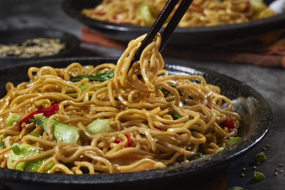 A pair of chopsticks pick up Lo mein noodles. The Asian American Resource Center held a noodle kitchen night Monday to celebrate the Chinese New Year. (Getty Images) 