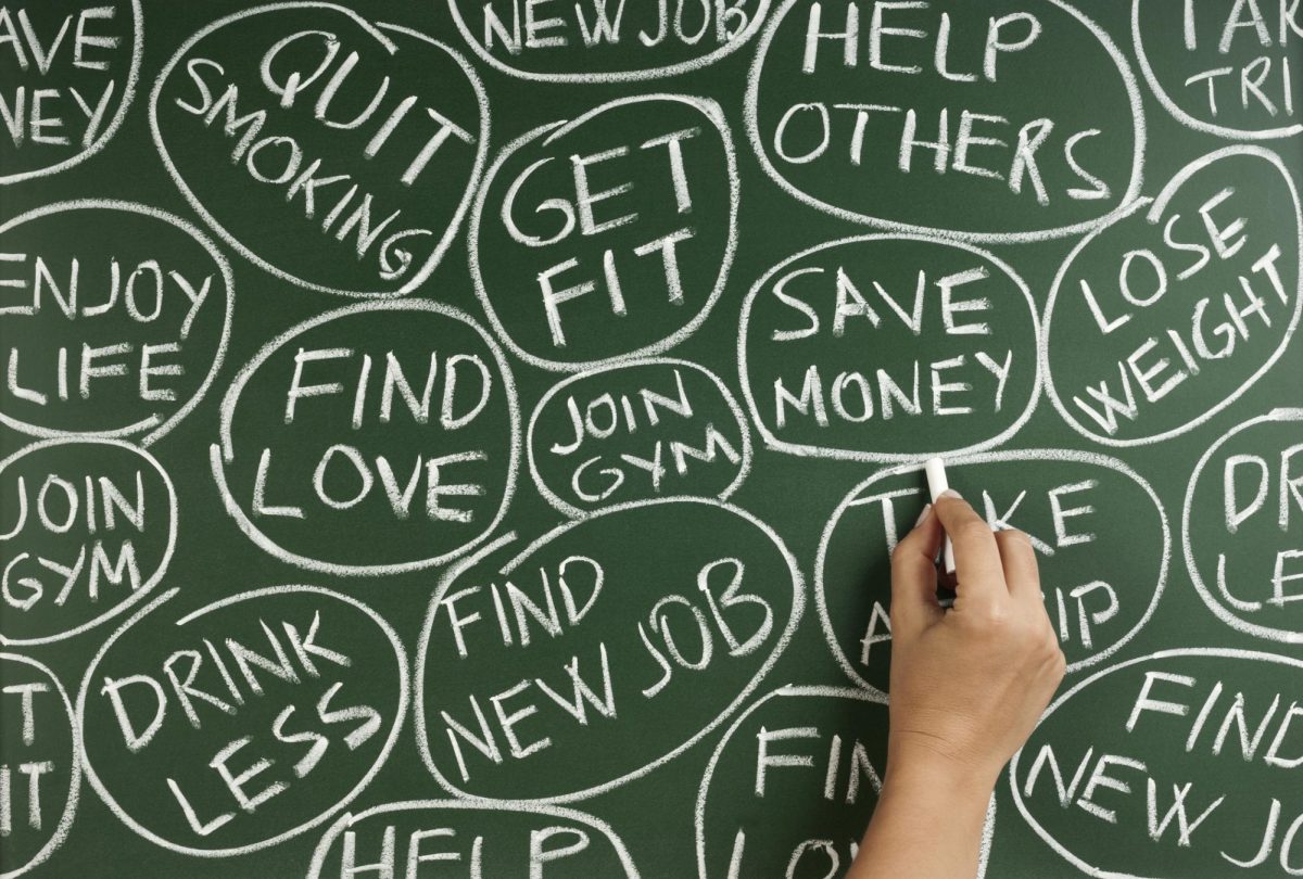 A person writes down their many New Year’s resolutions on a chalkboard. New Year resolutions are hard to maintain, so here are some tips to help you keep up with them. (Getty Images)