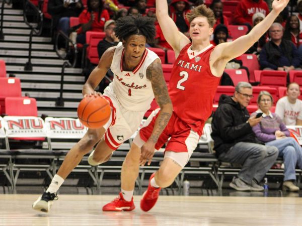 NIU sophomore guard Quentin Jones (1) drives past Miami Universirty sophomore guard Evan Ipsaro (2) during the Huskies’ 84-69 loss to the RedHawks on Tuesday night inside the Convocation Center in DeKalb. Jones led the game with 21 points, crossing the 20-point threshold for the sixth time this season. (Ethan Rodriguez | Northern Star)