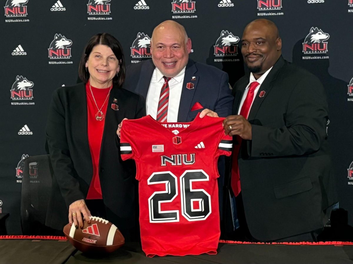 NIU President Lisa Freeman (left), NIU Vice President and Director of Athletics Sean Frazier and NIU head football coach Thomas Hammock pose for a photo after a press conference held in the McCareins Auditorium inside the Yordon Center in DeKalb. NIU’s membership agreement with the Mountain West Conference, which the school will join as a football-only affiliate in 2026, was obtained by the Northern Star on Thursday. (Edison Miller | Northern Star)