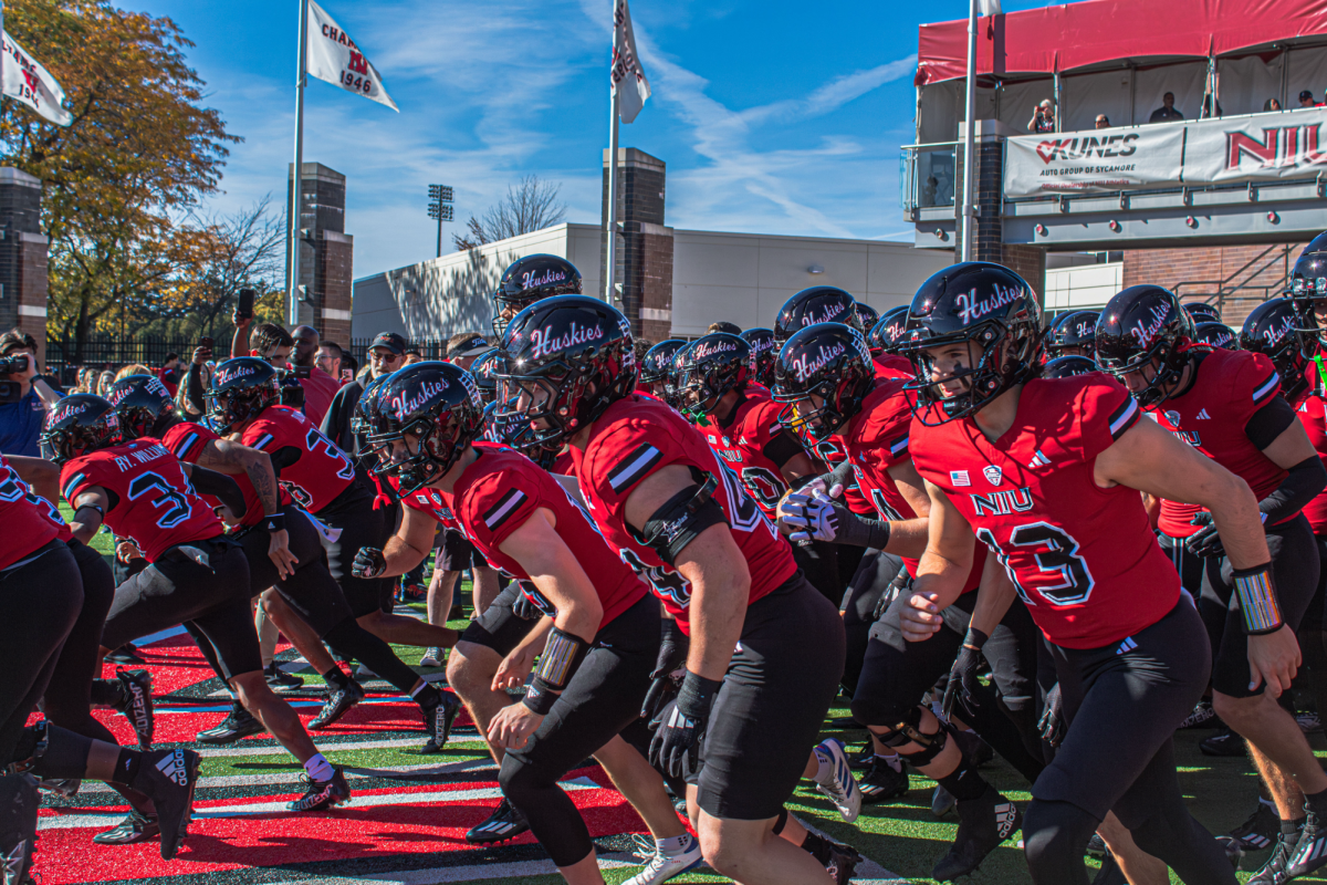 NIU football players run onto the field before the Huskies’ 117th Homecoming game against the University of Toledo on Oct. 19 at Huskie Stadium in DeKalb. NIU will play its final season in the Mid-American Conference in 2025 before joining the Mountain West Conference as a football-only affiliate. (Totus Tuus Keely | Northern Star)