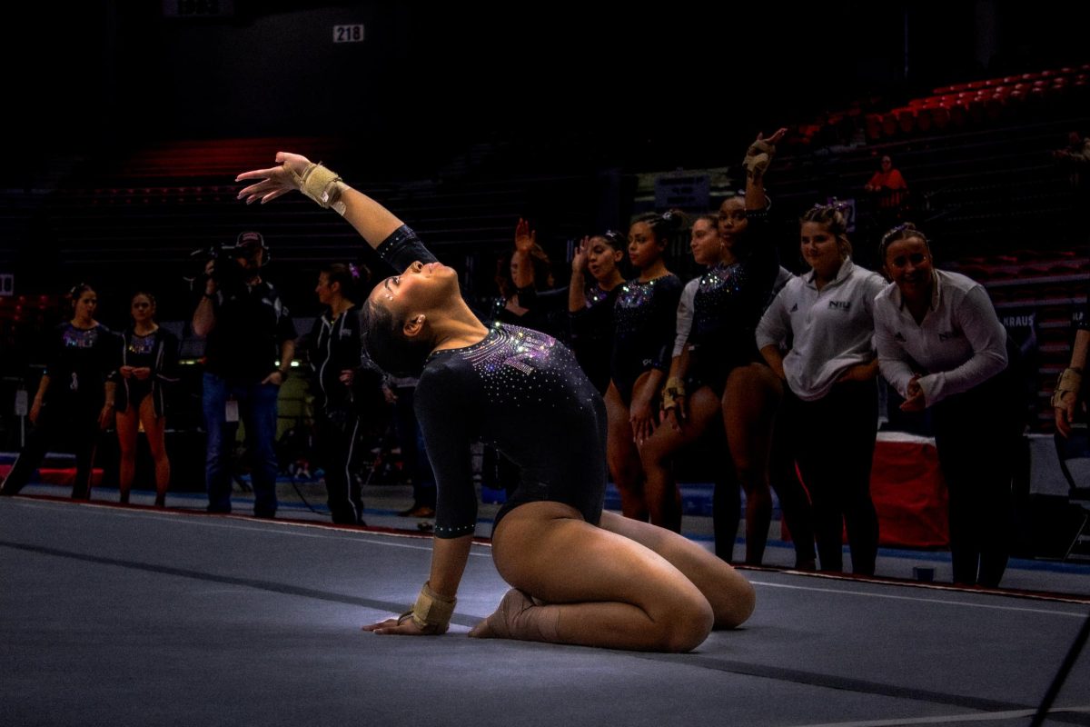 NIU gymnastics freshman Drake White looks up to the sky after crawling to the corner during her floor routine in the Huskies' meet against Illinois State University Friday at the Convocation Center in DeKalb. The Huskies lost to Illinois State Tuesday by a score of 193.92-192.950. (Totus Tuus Keely | Northern Star)