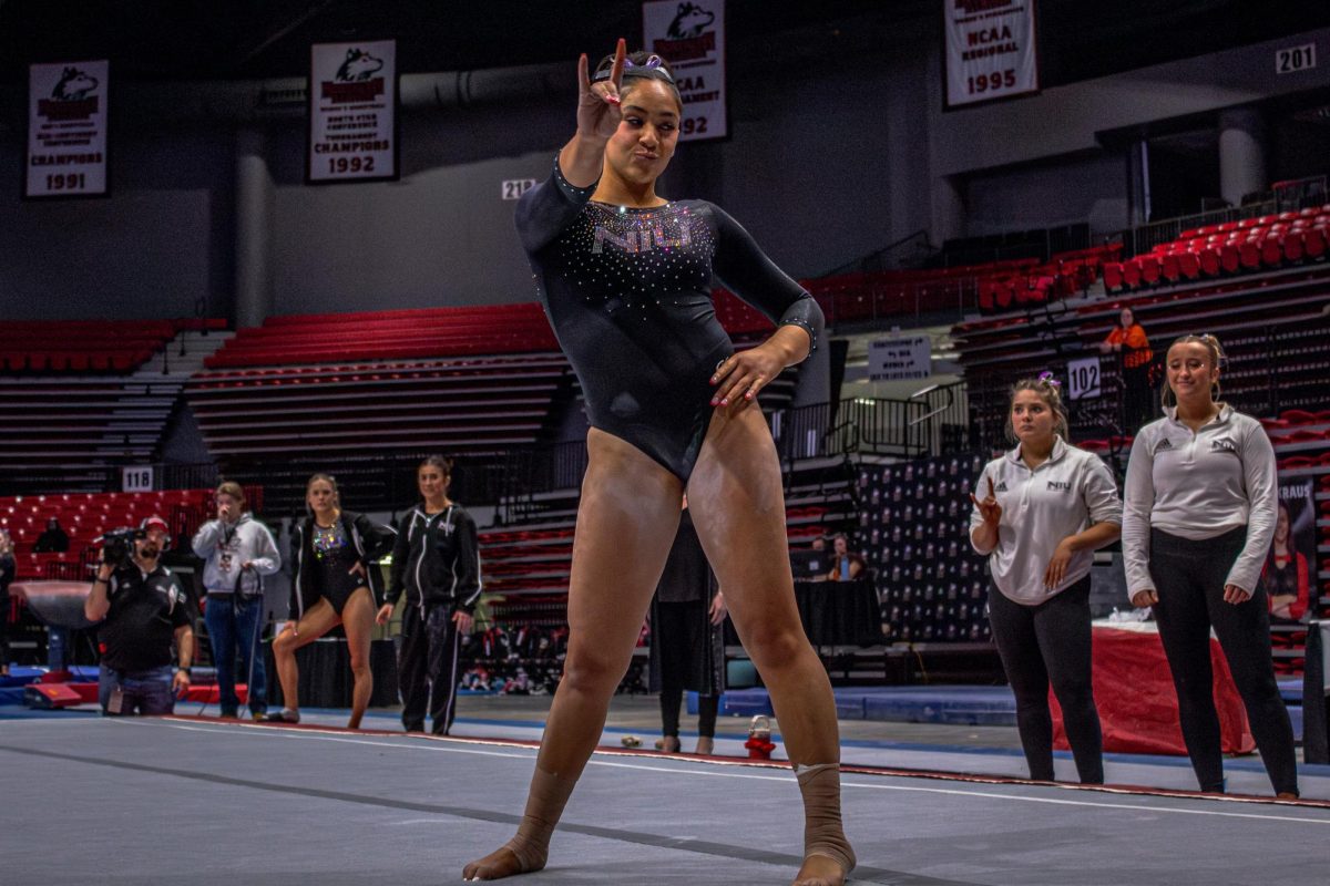 NIU gymnastics sophomore Dawson Sallee poses after completing her event Friday against Illinois State University at the Convocation Center in DeKalb. The Huskies fell short of Illinois State by a score of 196.150-192.275 on Friday as NIU hosted it's senior night. (Totus Tuus Keely | Nothern Star)