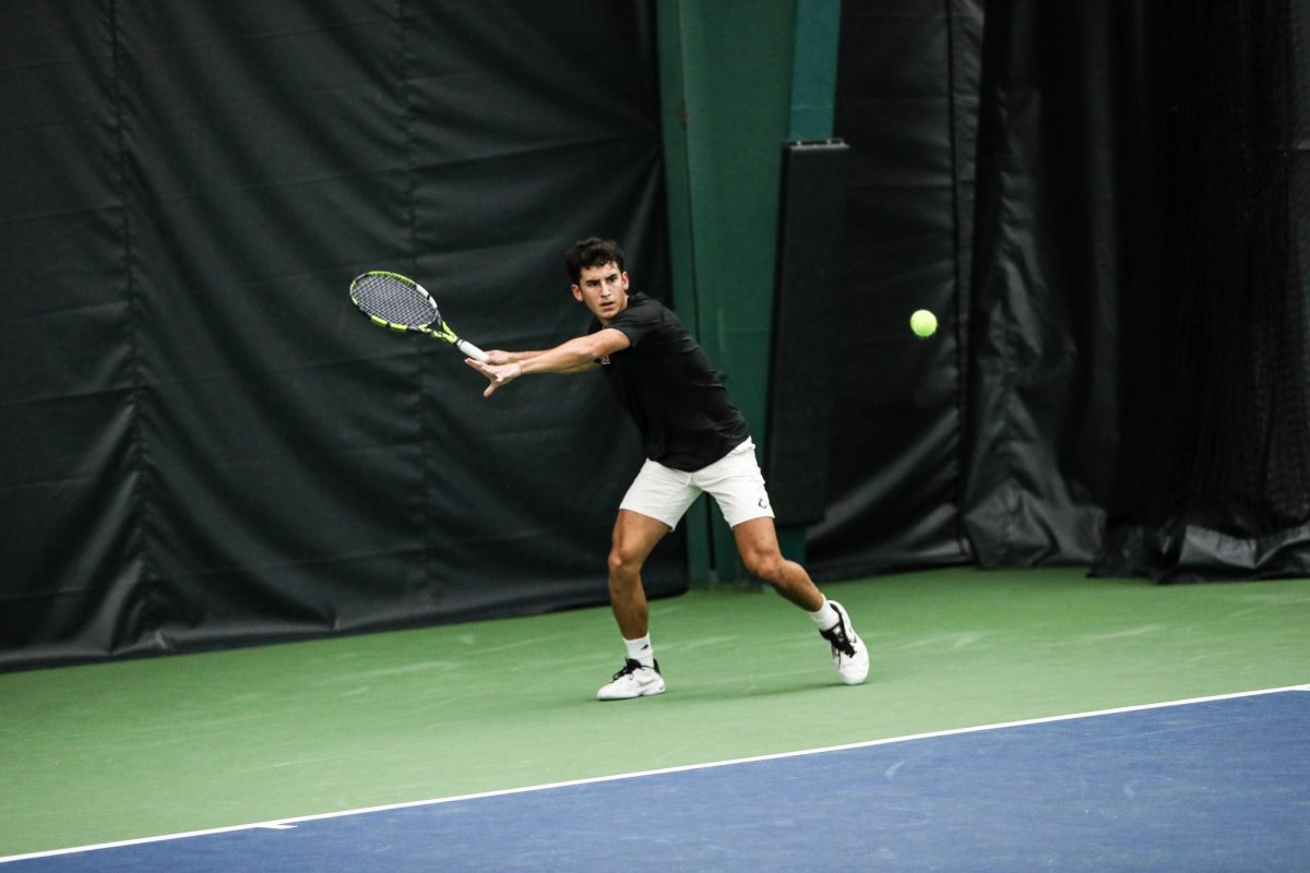 NIU men's tennis junior Iker Dellien Velasco winds up, preparing to return the tennis ball over the net at the Mid-American Indoor Championships on Oct. 27. The Huskies beat Judson University by a score of 7-0 Sunday in DeKalb. (Ashley Huss | Western Michigan University Athletics) 