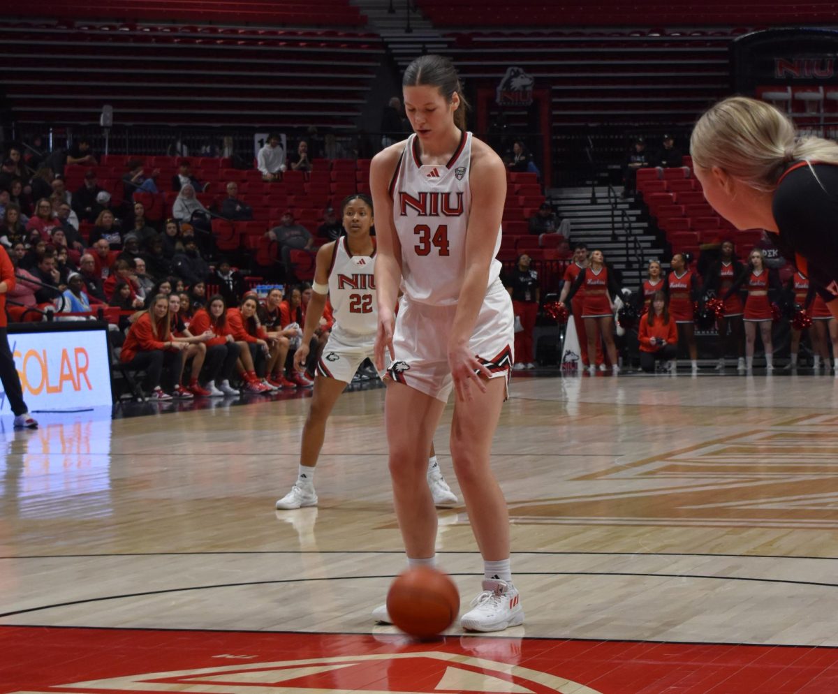 NIU women's basketball graduate student forward Brooke Stonebraker (34) begins a free throw attempt while NIU junior guard Alecia Doyle (22) prepares to return to defense Saturday at the Convocation Center in the Huskies' matchup against the MAC-leading Ball State University Cardinals.  The Huskies fell to the Cardinals by a score of 81-62. (Erin Marie Barker | Northern Star)