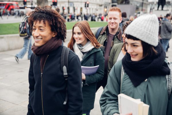 A photo shows a group of multi-ethnic students walking to university. Enrollment statistics released by NIU show the university has 14,158 total students enrolled in Spring 2025. (Getty Images)