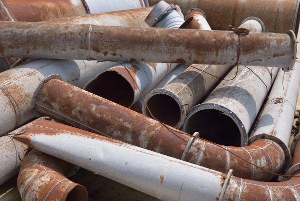 Rusty and damaged industrial pipes and other metal products sit stacked together. The city of DeKalb will be replacing the remaining lead pipes in the city in accordance with the Safe Drinking Water Act of 1974. (Getty Images)