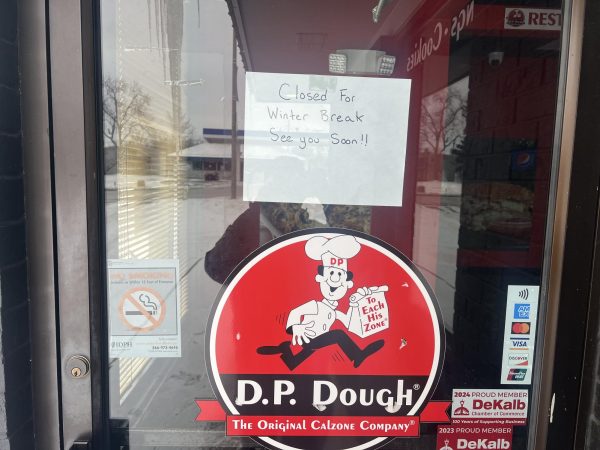 A sign on the entrance of D.P. Dough says the restaurant is closed for winter break. The restaurant has faced multiple closures since its opening in 2023, with court documents showing the city is attempting to collect $26,000 in taxes, penalties and late fees from the business. (Devin Oommen | Northern Star)