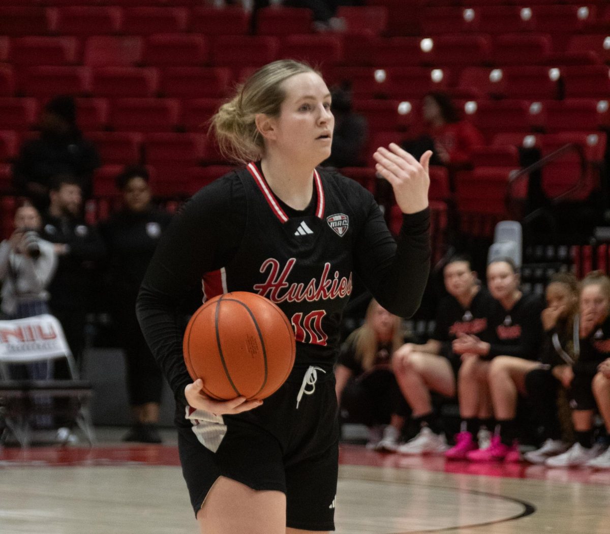 NIU women's basketball graduate student guard Chelby Koker directs the Huskies' offense after reaching the top of the key on Wednesday at the Convocation Center during NIU's final home game of the season against the University of Toledo. Despite NIU falling to Toledo by a score of  79-70, Koker finished with a game-leading 24 points. (Katherine Follmer | Northern Star)