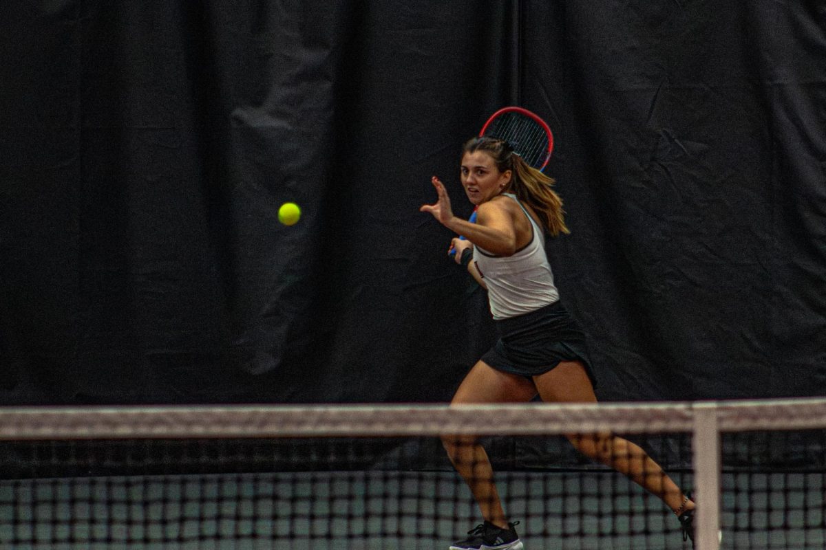 NIU women’s tennis junior Isabella Righi returns a serve during her doubles match with freshman Lucia Yecora against Lewis University on Feb. 15. The Huskies won a 5-2 team match against the Marquette University Golden Eagles on Wednesday. (Totus Tuus Keely | Northern Star)