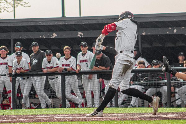 NIU baseball senior right fielder JP Gauthier (13) hits a foul ball during the second game of a doubleheader against the University of Akron on April 18. The Huskies lost a 7-3 game on Saturday to concede the series to the Zips. (Totus Tuus Keely | Northern Star)