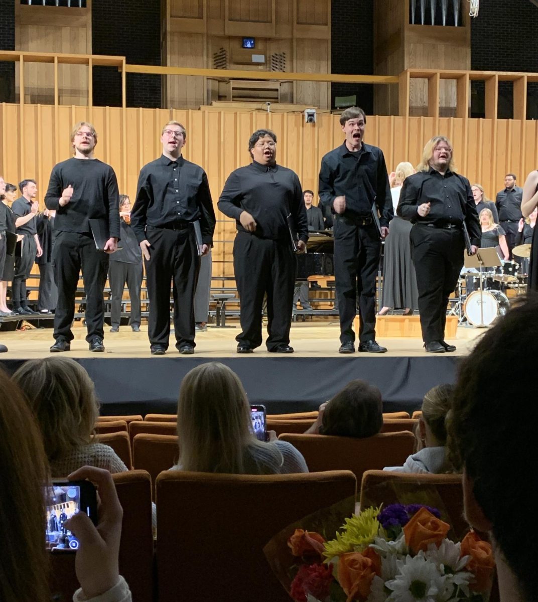 Five chorus singers perform in front of the audience. The NIU Chamber Choir, NIU University Chorus and NIU Concert Choir performed pieces from different time periods and places. (Ethan Quirk | Northern Star)