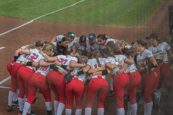 The NIU softball team enters the huddle before their first match against Ohio University on March 28. Sports Editor Edison Miller breaks down his three greatest takeaways from the Huskies’ 2025 season so far. (Totus Tuus Keely | Northern Star)