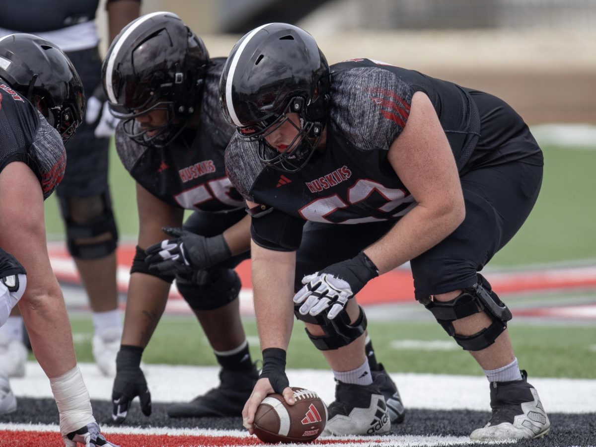 NIU redshirt sophomore offensive lineman Luke Skartvedt (53) and redshirt junior offensive lineman Abiathur Curry (55) line up before the snap during a spring practice April 5 at Huskie Stadium. Skartvedt and Curry are both expected to start on the Huskies’ offensive line in 2025. (Tim Dodge | Northern Star)