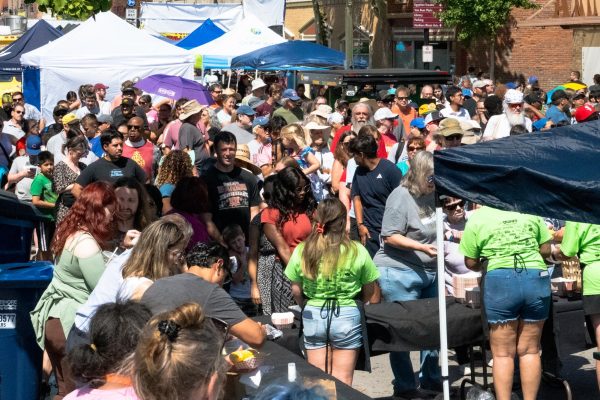 Corn Fest attendees line up for the free corn boil at Corn Fest on Saturday at Lincoln Highway, East of North 4th Street. Corn Fest took place on Lincoln Highway from 1st Street to 4th street and extended into 2nd and 3rd street to Oak Street. (Totus Tuus Keely | Northern Star)