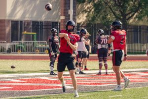 NIU redshirt sophomore quarterback Josh Holst (15) throws a pass during practice on Aug. 13 at Huskie Stadium in DeKalb. Holst will be NIU's starting quarterback in 2025 after starting three games last season. (Totus Tuus Keely | Northern Star)