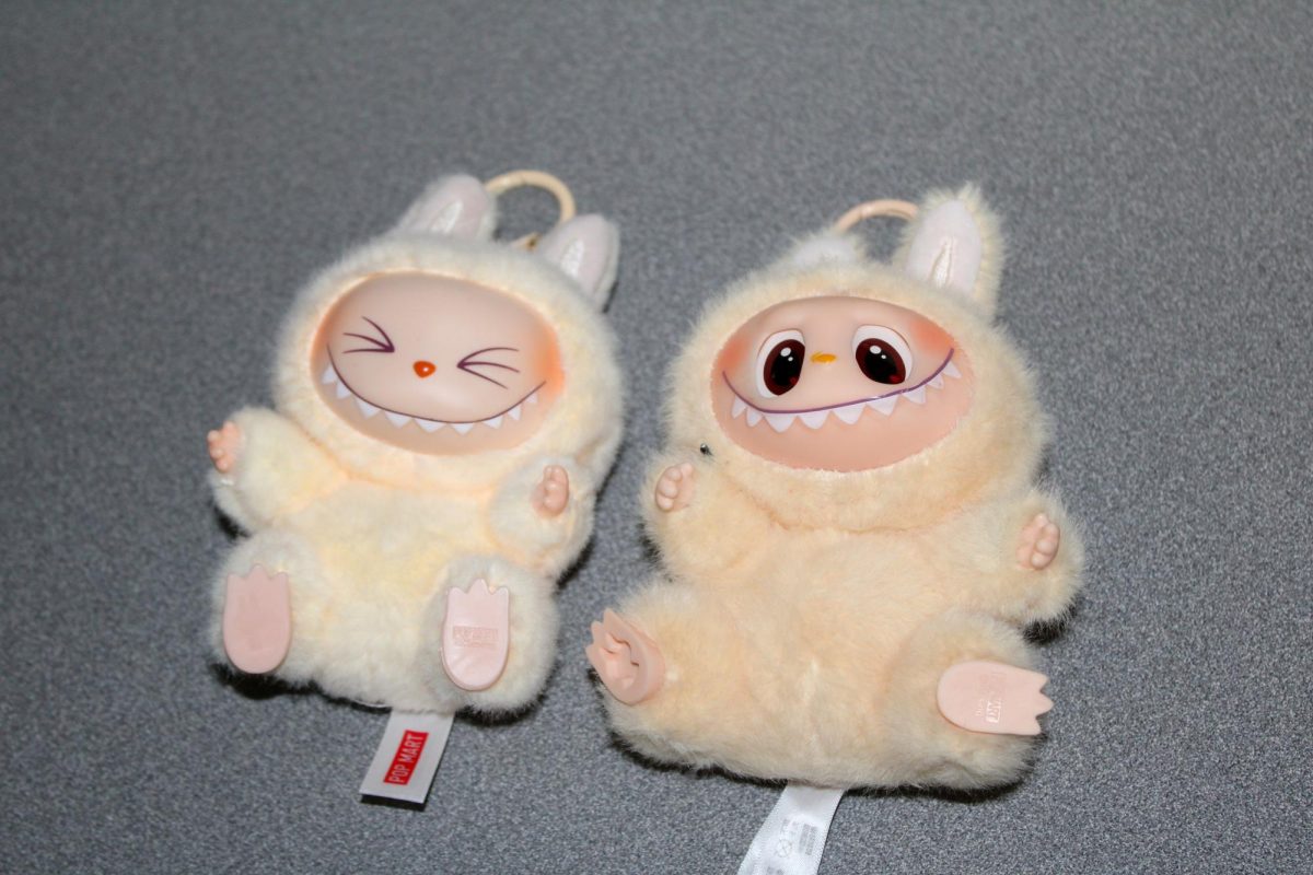 A Labubu and a Lafufu, a fake Labubu, lay on a table with their feet in the air. How sturdy a Labubus’ feet and head are indicators of whether the plush keychains are real or a knockoff.
