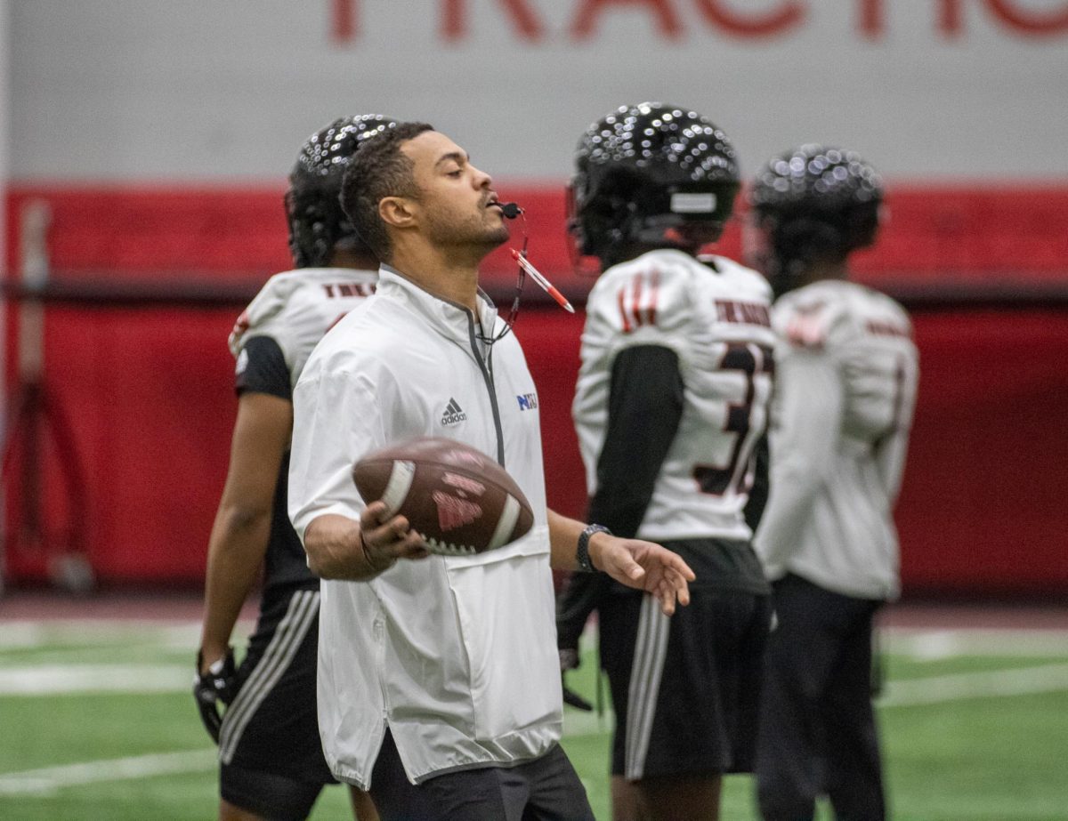 NIU safeties coach Kai Ross holds a football during practice on March 27 inside the Chessick Practice Center in DeKalb. Ross was elevated to an assistant coach position in January after working as a graduate assistant for the Huskies' defense last season. (Tim Dodge | Northern Star)
