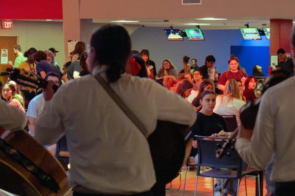 A group of students watch the NIU Mariachi Band perform on Saturday night for Welcome Holmes in Club 1895. NIU provided events for incoming first-years and returning students to participate in from Wednesday to Sunday. (Totus Tuus Keely | Northern Star)