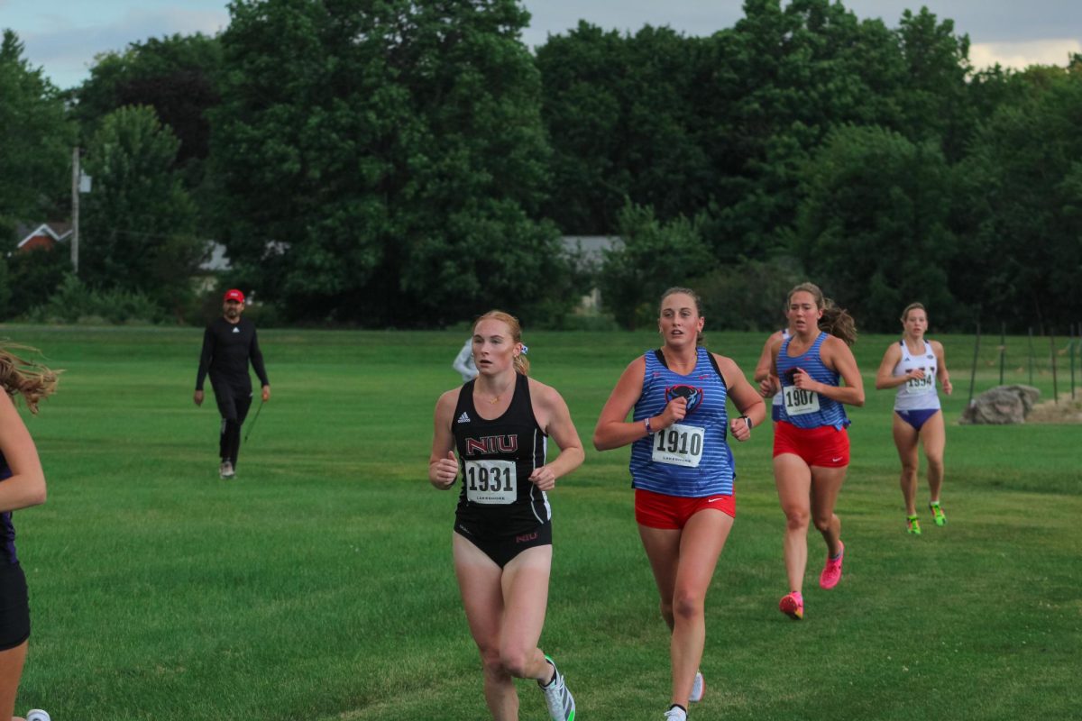 NIU cross country then-senior runner Carly Leonard rounds a corner while running at the NIU Huskie Opener on Sep.6, 2024. The Huskies placed 7th with 179 points at the Fighting Illini Open on Friday. (Totus Tuus Keely | Northern Star)
