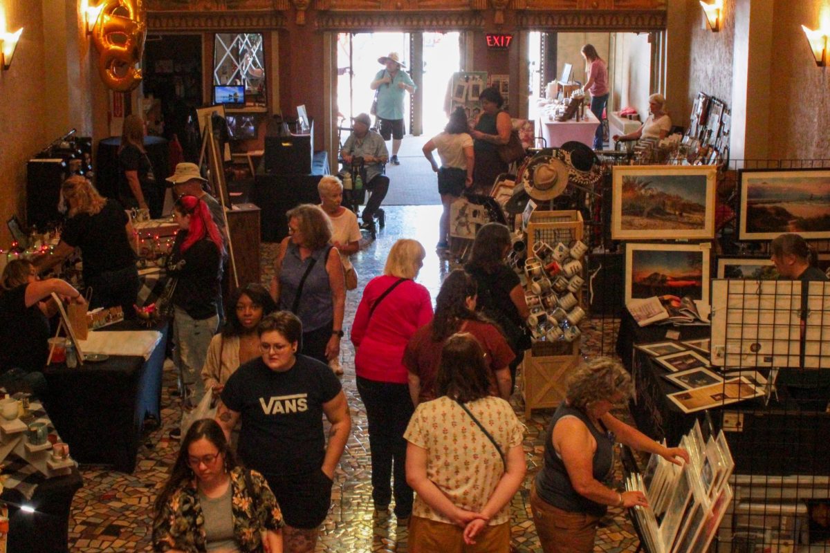 DeKalb Back Alley Market attendees browse through the vendors set up inside the Egyptian Theatre on Saturday. Several vendors were set up inside the First Floor of the Egyptian Theatre to create additional space for the DeKalb Back Alley Market. (Ethan Rodriguez | Northern Star)