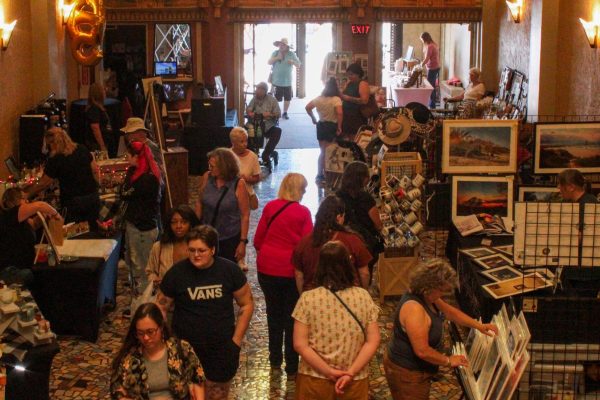 DeKalb Back Alley Market attendees browse through the vendors set up inside the Egyptian Theatre on Saturday. Several vendors were set up inside the First Floor of the Egyptian Theatre to create additional space for the DeKalb Back Alley Market. (Ethan Rodriguez | Northern Star)