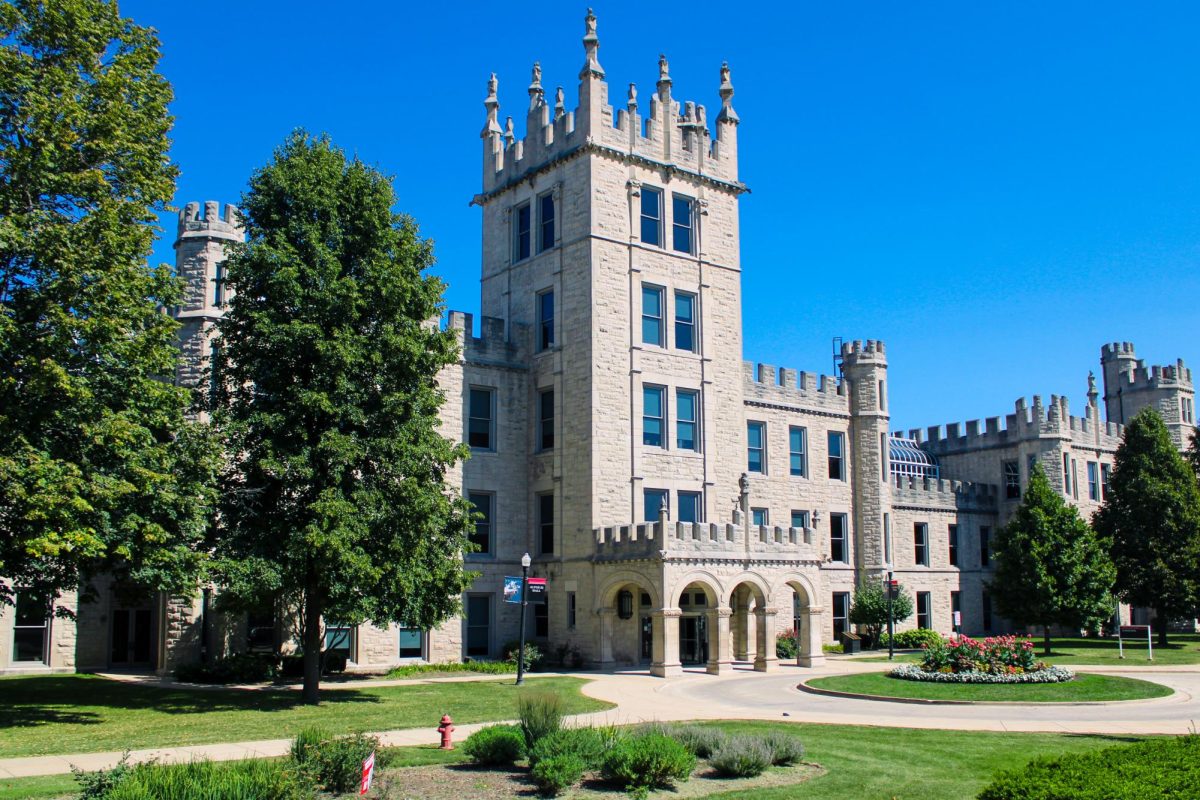 Altgeld Hall sits surrounded by trees and other foliage. “A Legacy of Excellence: 60 Years of Printmaking at NIU” opened on Aug. 27 alongside the “Legacies on Display: The Forbidden and Venerated Arts of Burma” in Altgeld Hall. (Ethan Rodriguez | Northern Star)


