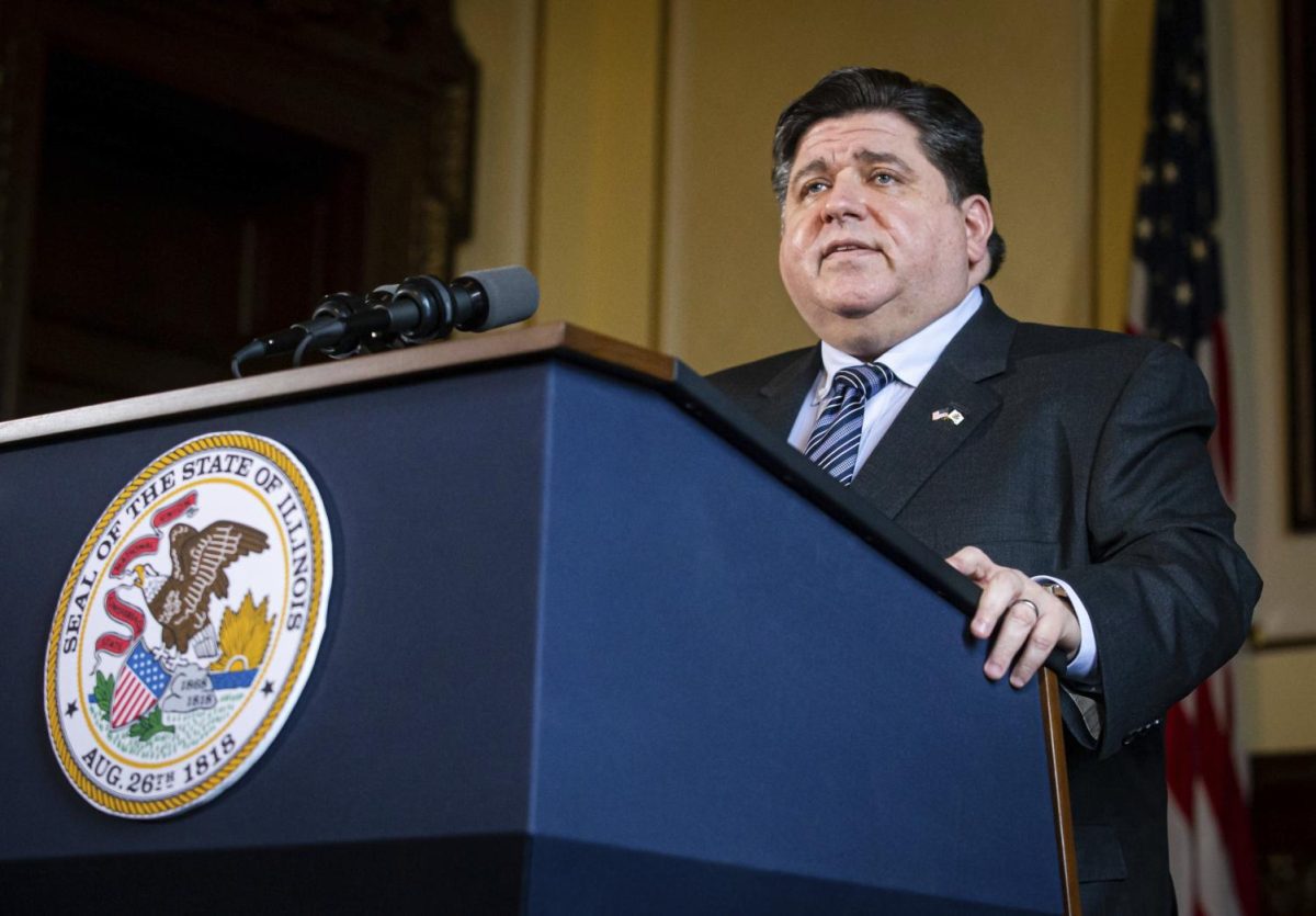 Gov. JB Pritzker speaks at a podium during a press conference at the Illinois State Capitol on Jan. 11, 2021. Pritzker helped launch the One Click College Admit program on Aug. 19, which automatically enrolls students in public Illinois universities and colleges as long as they meet the minimum GPA requirement. (Associated Press)